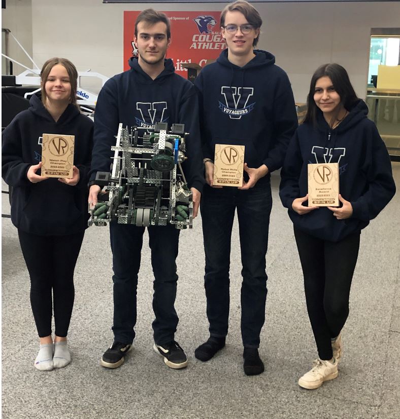 The team with their robot and awards