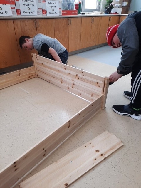 Two students building a planter box