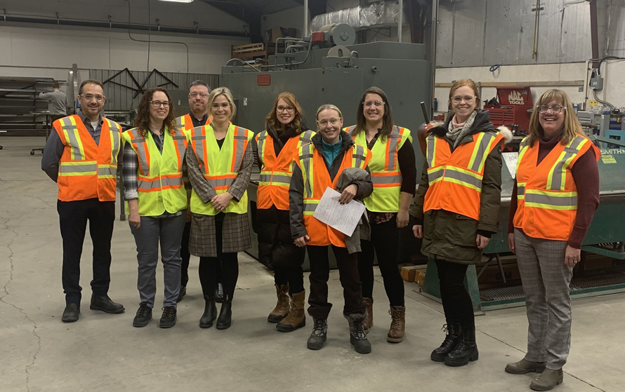 Employer pose pour la caméra avec leur veste de circulation